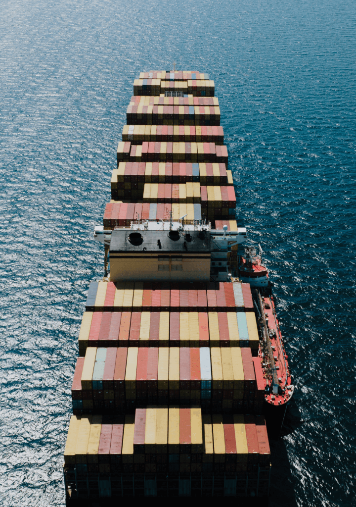 aerial persepective of cargo ship on open sea with containers
